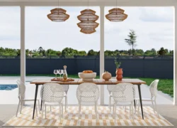 a dining room with a table and chairs next to a pool